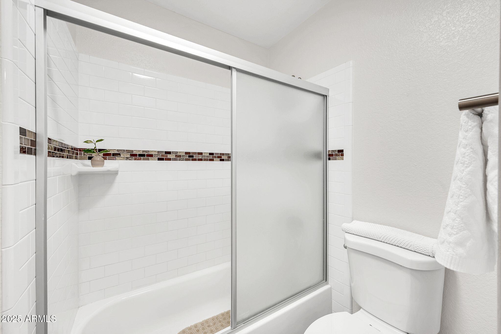 8787 East Mountain View Road, Unit 2100 Scottsdale, AZ 85258 - Photo 31 of 47 a bathroom with a shower and a toilet