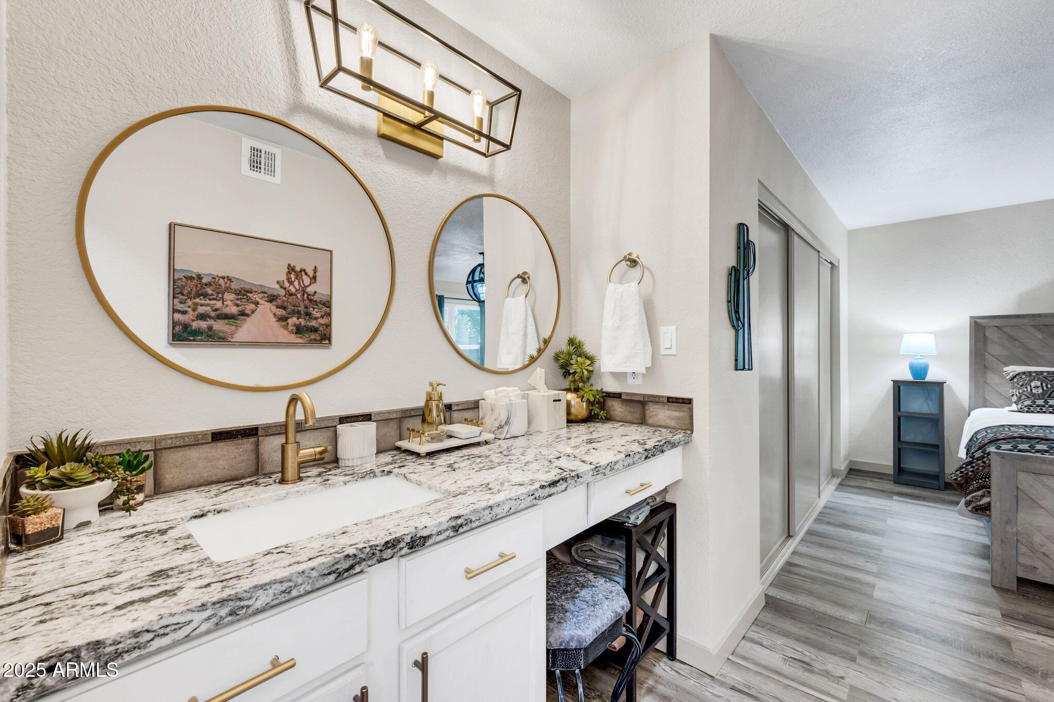 8787 East Mountain View Road, Unit 2100 Scottsdale, AZ 85258 - Photo 33 of 48 a bathroom with double vanity sinks and a mirror