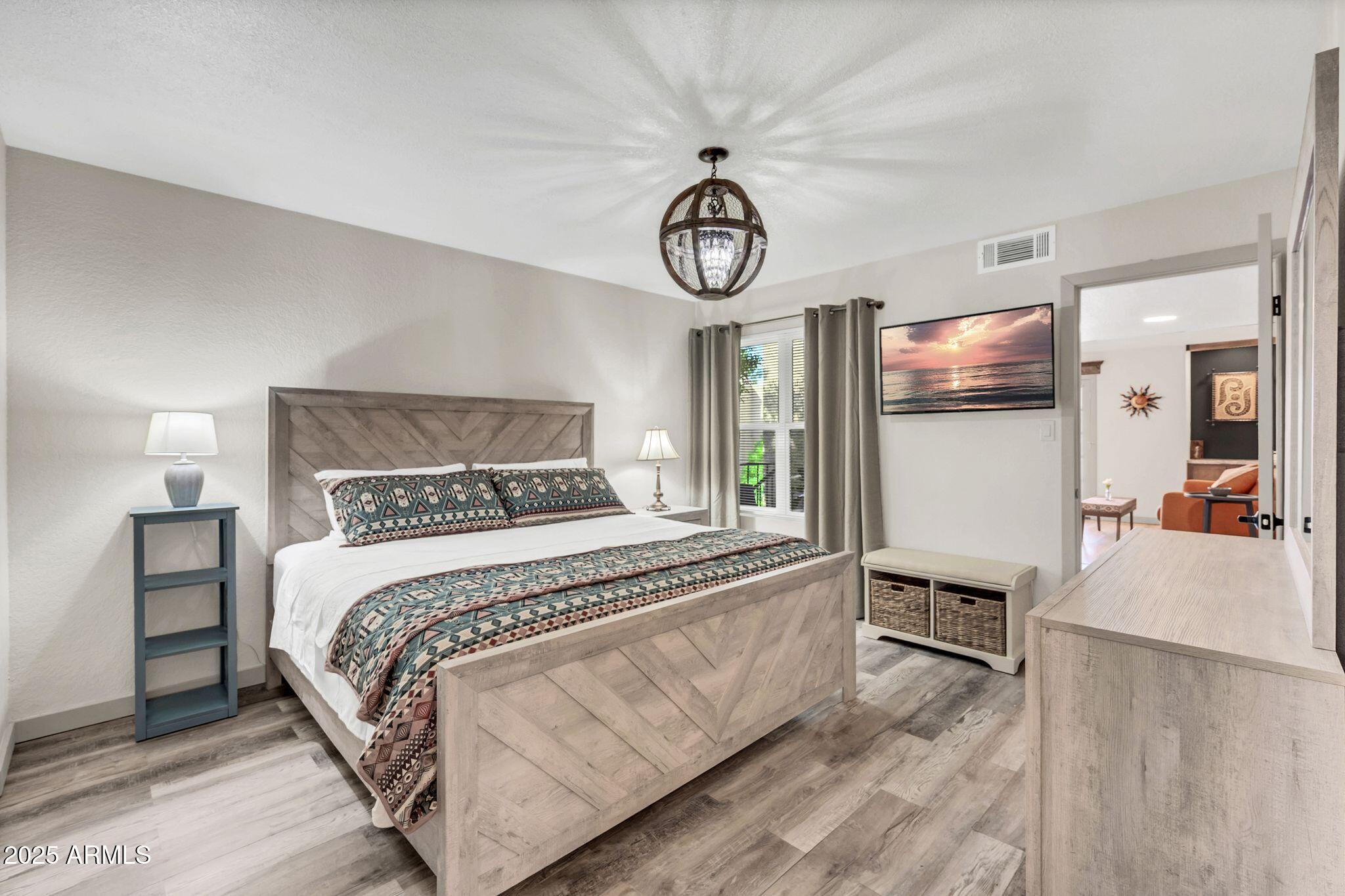 8787 East Mountain View Road, Unit 2100 Scottsdale, AZ 85258 - Photo 35 of 48 a bedroom with a bed and a view of kitchen