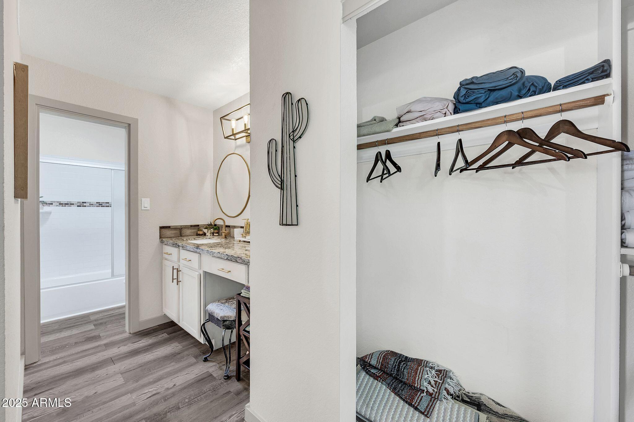 8787 East Mountain View Road, Unit 2100 Scottsdale, AZ 85258 - Photo 36 of 48 a view of a room with wooden floor and white walls