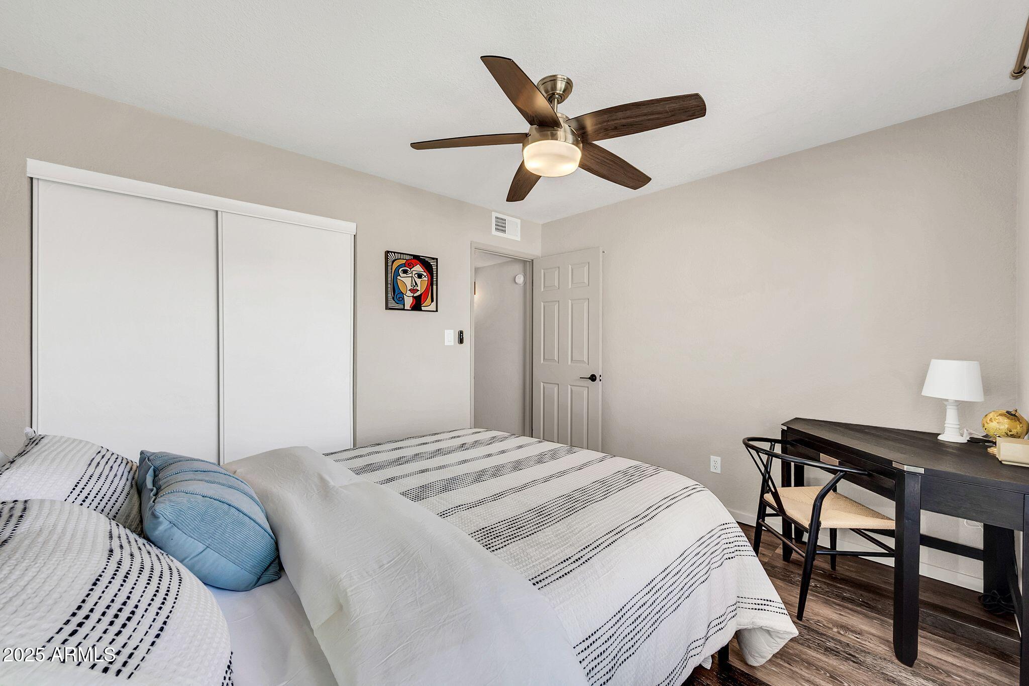 8787 East Mountain View Road, Unit 2100 Scottsdale, AZ 85258 - Photo 40 of 47 a bedroom with a bed and a dresser