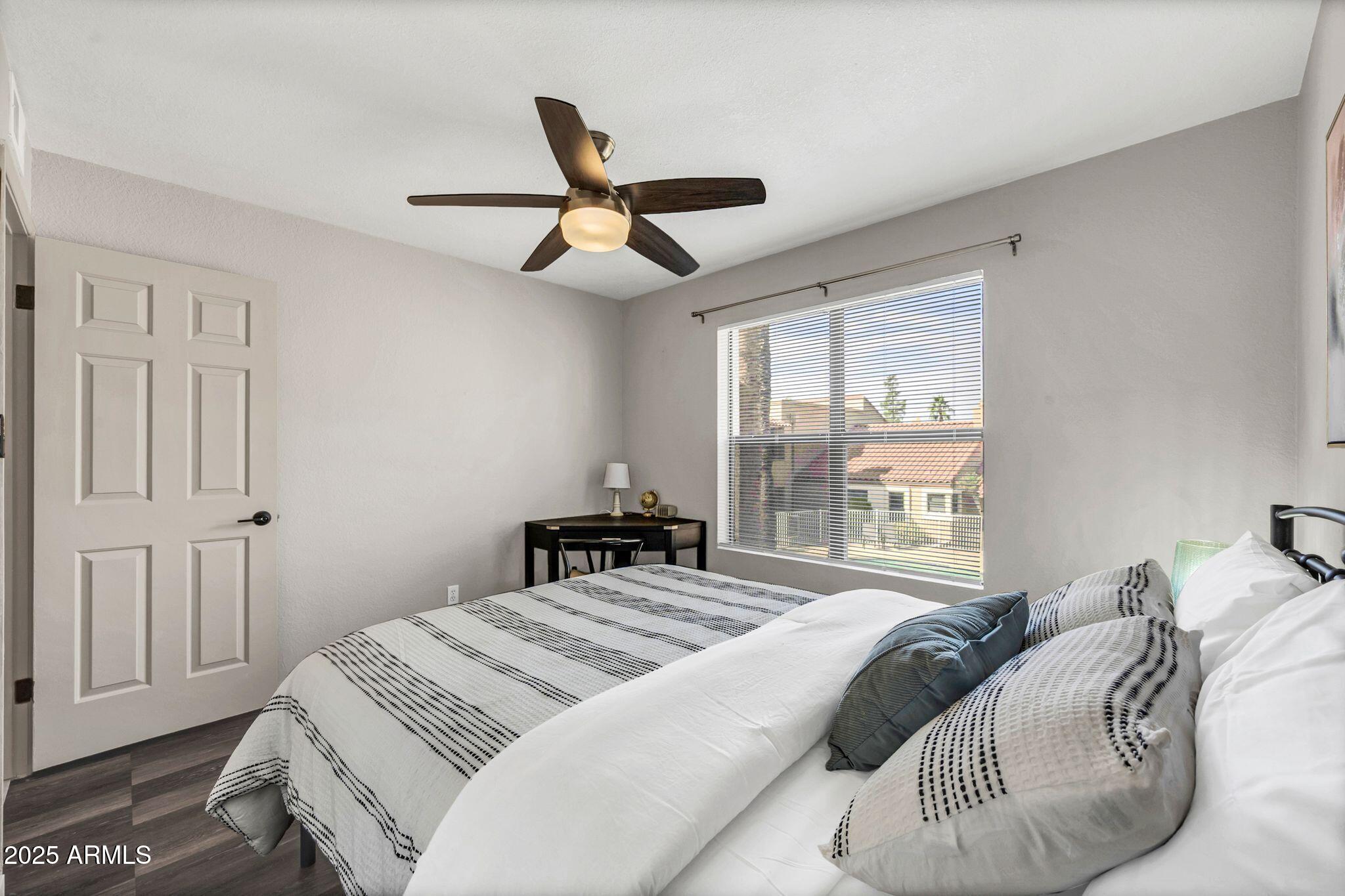 8787 East Mountain View Road, Unit 2100 Scottsdale, AZ 85258 - Photo 42 of 48 a bedroom with a bed and a large window