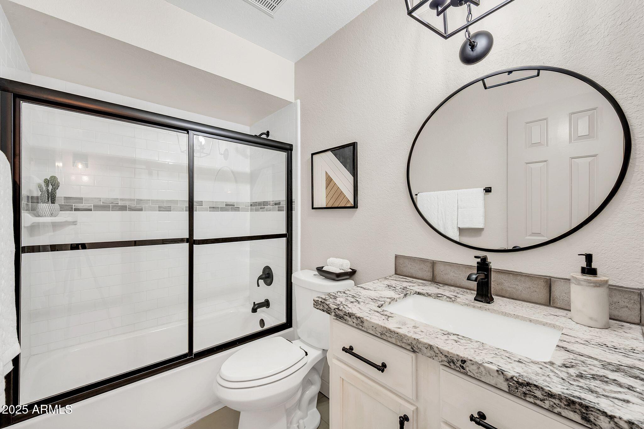 8787 East Mountain View Road, Unit 2100 Scottsdale, AZ 85258 - Photo 44 of 48 a bathroom with a toilet a sink and a mirror