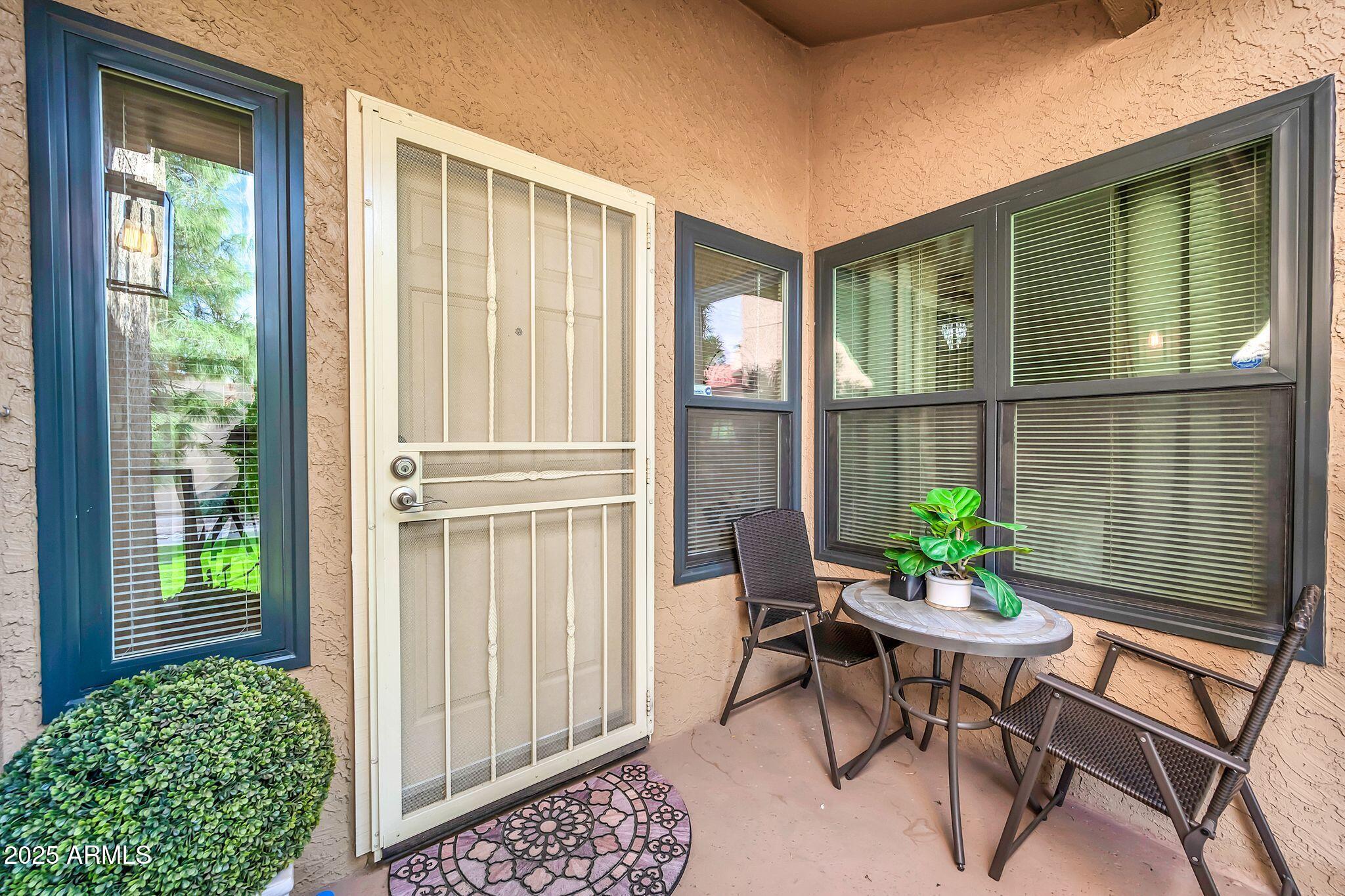 8787 East Mountain View Road, Unit 2100 Scottsdale, AZ 85258 - Photo 4 of 48 a balcony with furniture and a potted plant