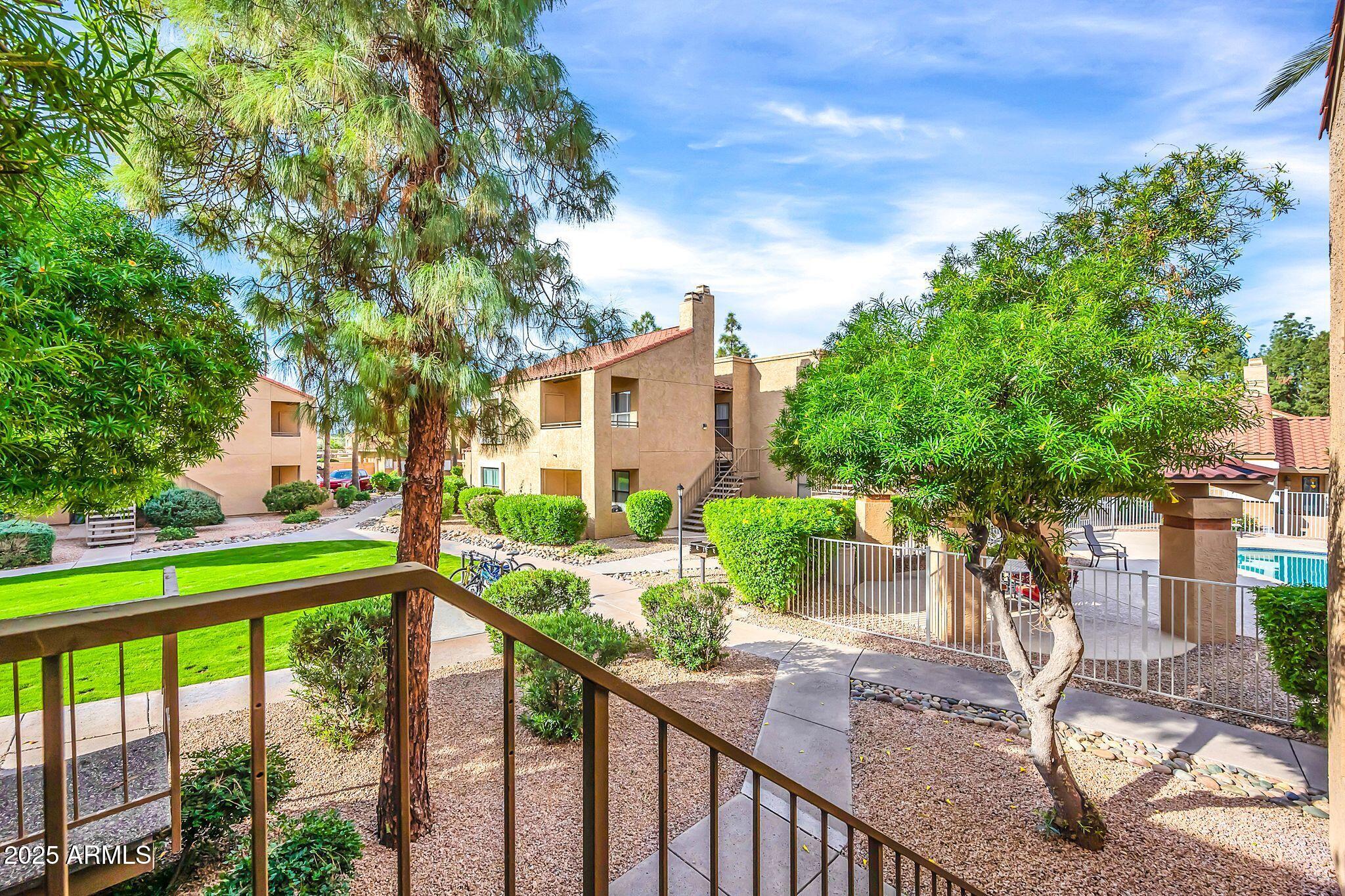 8787 East Mountain View Road, Unit 2100 Scottsdale, AZ 85258 - Photo 5 of 48 a view of a house with a large windows and a tree