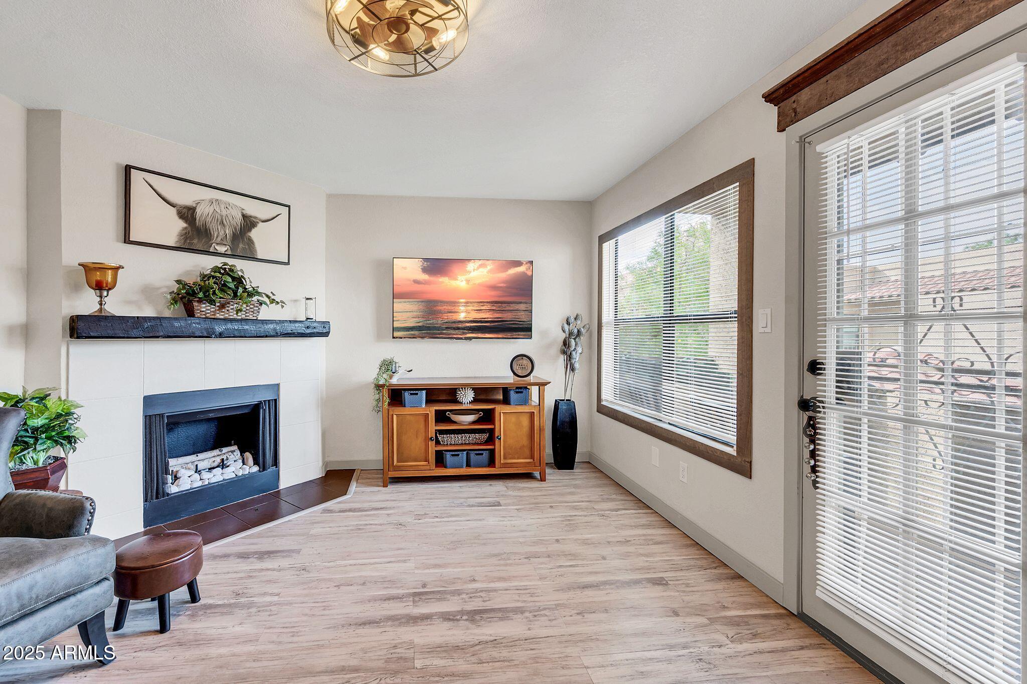 8787 East Mountain View Road, Unit 2100 Scottsdale, AZ 85258 - Photo 7 of 47 a living room with furniture a fireplace and a flat screen tv