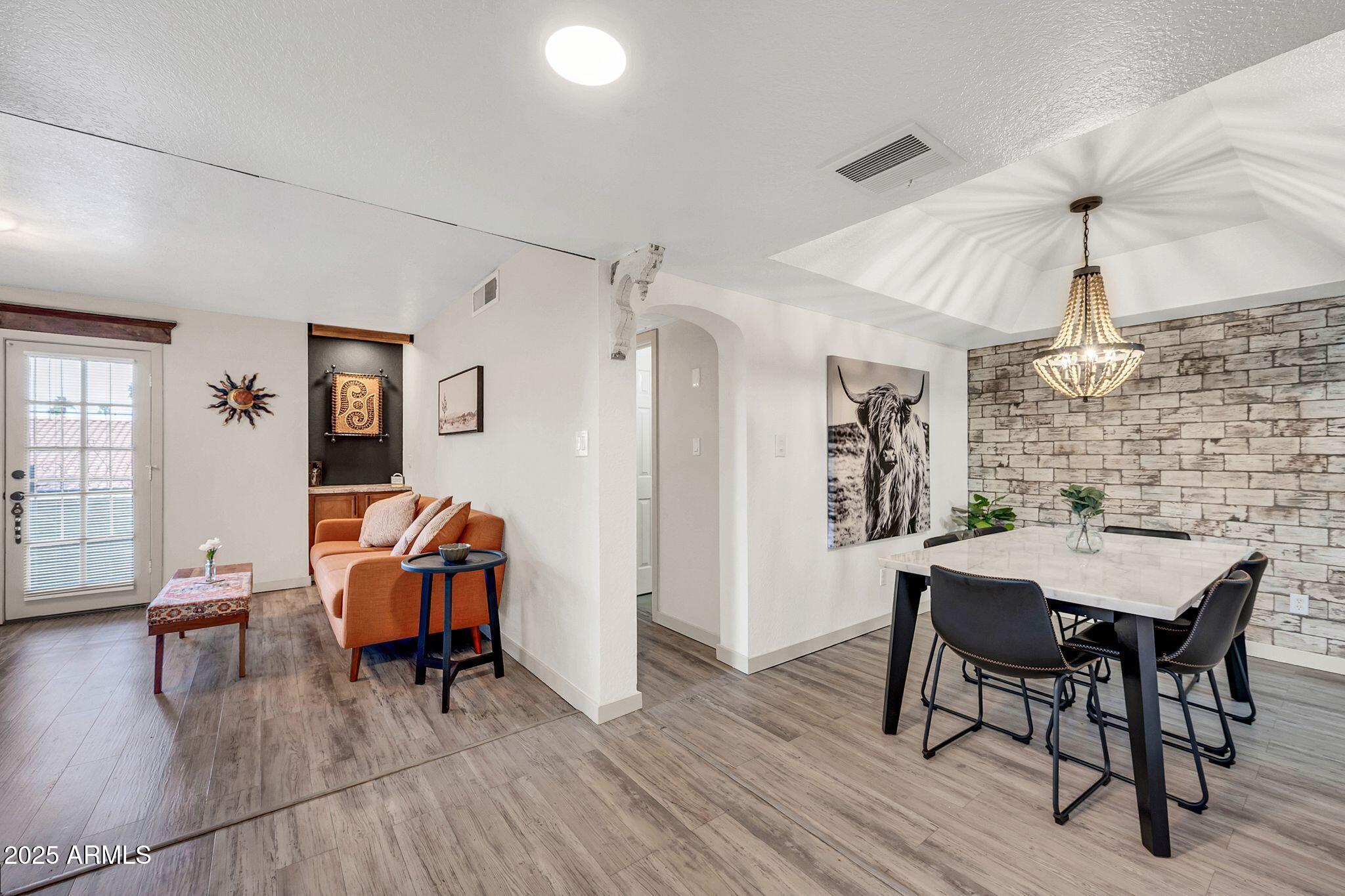 8787 East Mountain View Road, Unit 2100 Scottsdale, AZ 85258 - Photo 9 of 48 a view of a dining room with furniture and wooden floor