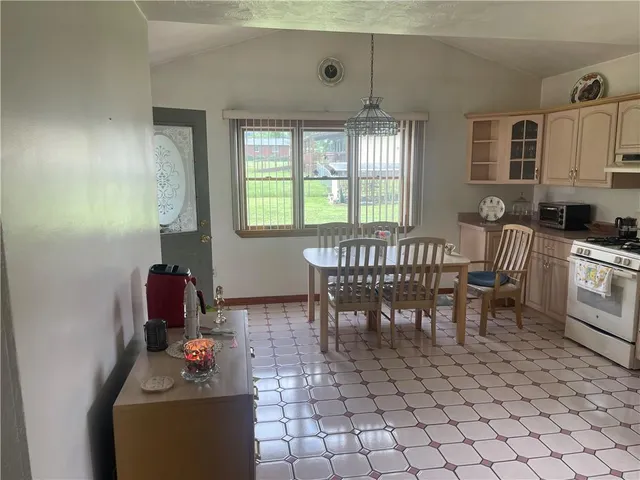 a kitchen that has a lot of cabinets in it and appliances