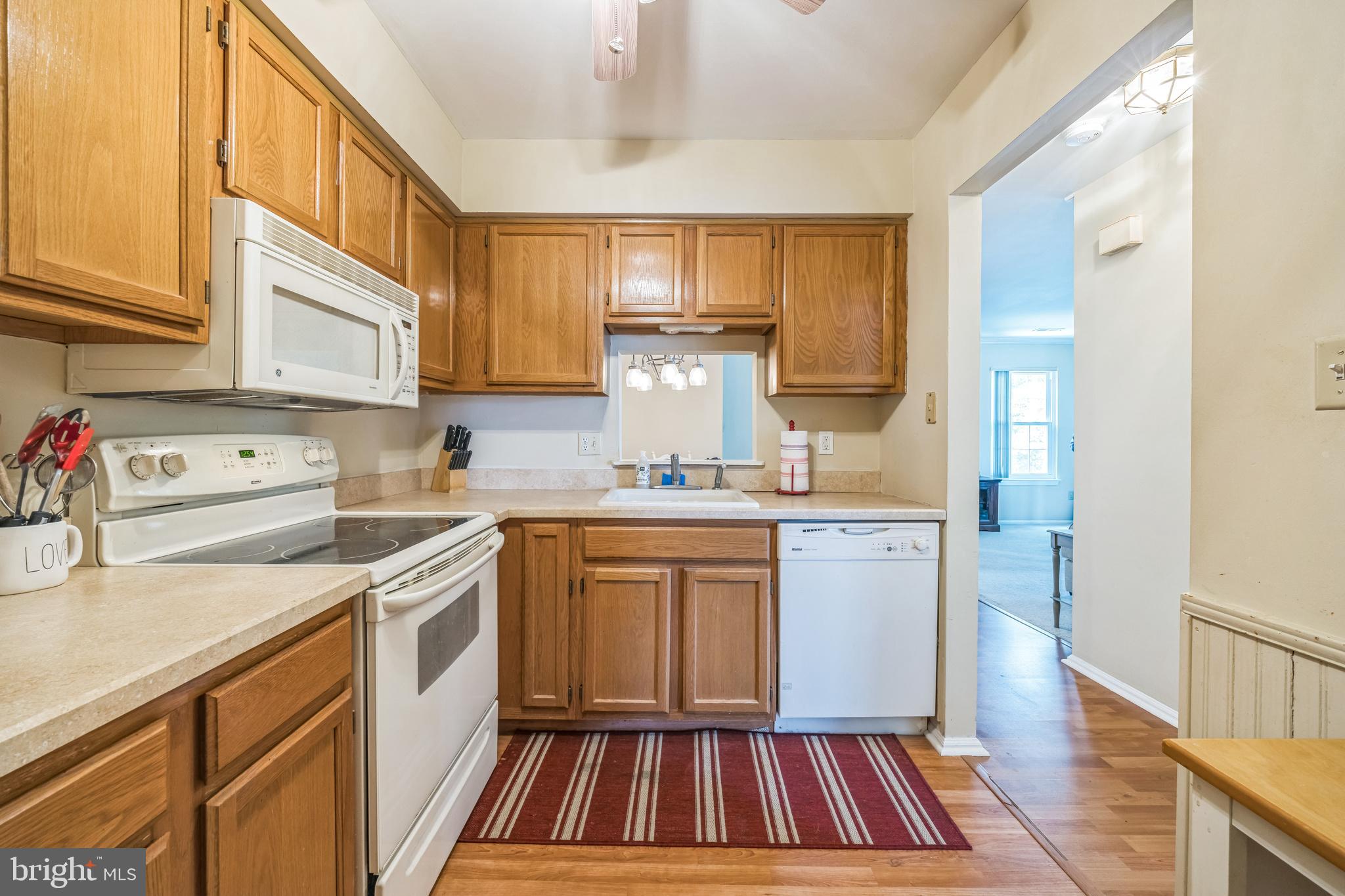 402 B Violet Drive Mount Laurel, NJ 08054 - Photo 18 of 35 a kitchen with a sink stove and cabinets