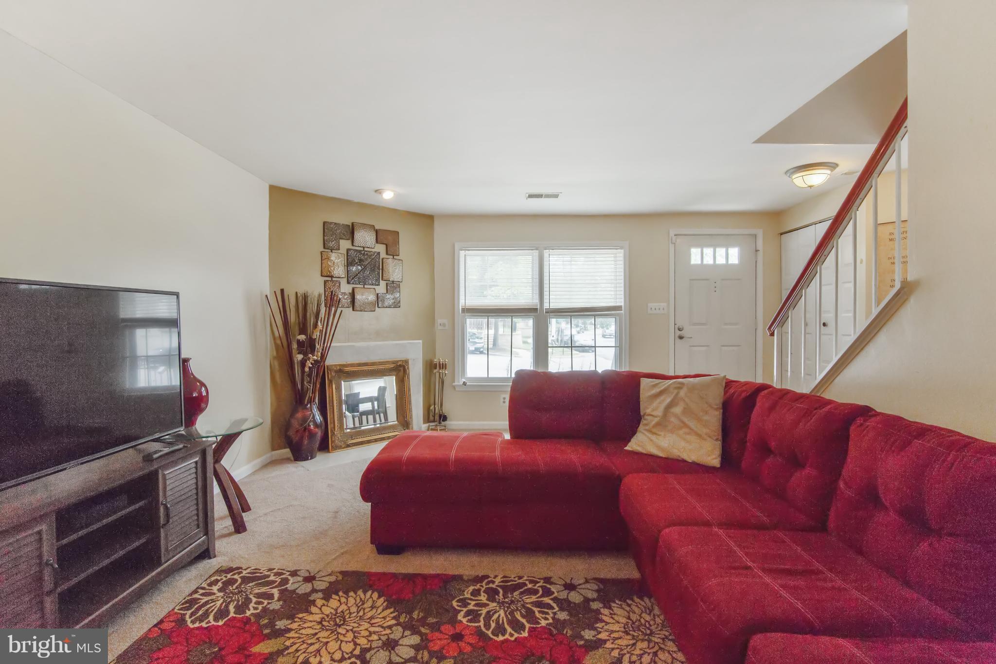 9304 Palmer Place, Unit 5 Laurel, MD 20708 - Photo 8 of 30 a living room with furniture and a flat screen tv