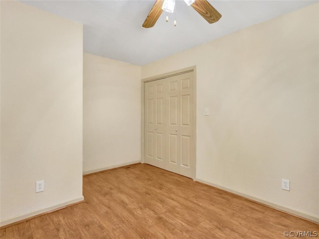 15441 Corinth Road Ivor, VA 23866 - Photo 17 of 28 an empty room with a ceiling fan and wooden floor