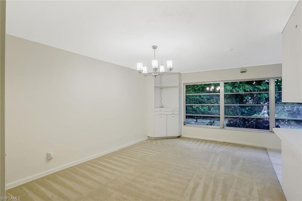 3888 Crayton Road Naples, FL 34103 - Photo 11 of 29 an empty room with windows