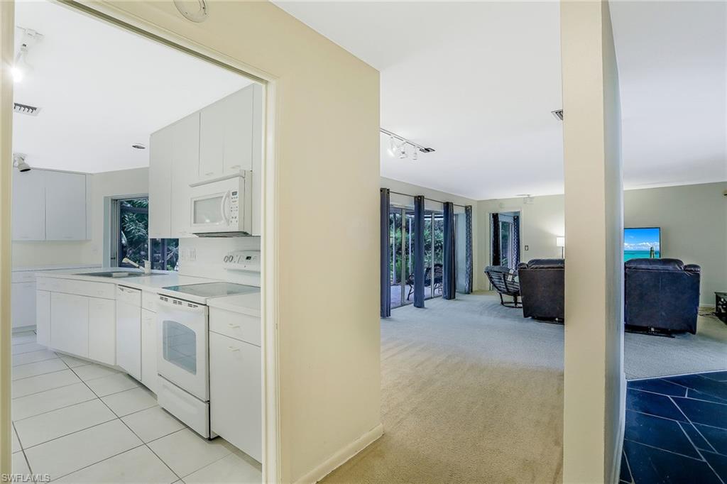 3888 Crayton Road Naples, FL 34103 - Photo 15 of 29 a view of a kitchen with cabinets and furniture