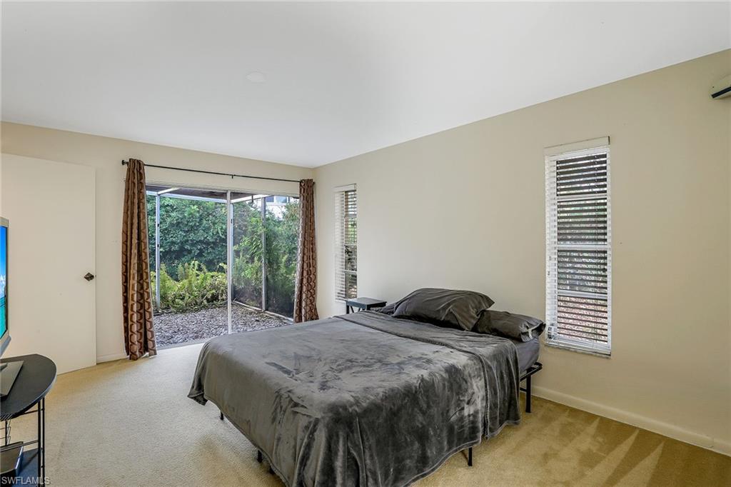 3888 Crayton Road Naples, FL 34103 - Photo 18 of 29 a bedroom with a bed and window