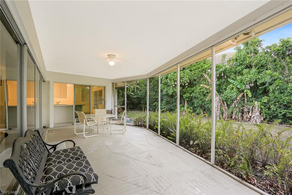 3888 Crayton Road Naples, FL 34103 - Photo 20 of 29 a living room with furniture and a large window