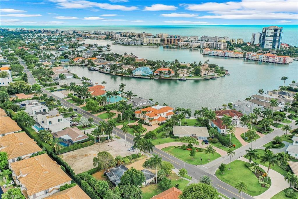 3888 Crayton Road Naples, FL 34103 - Photo 22 of 29 an aerial view of residential houses with outdoor space and lake view in back
