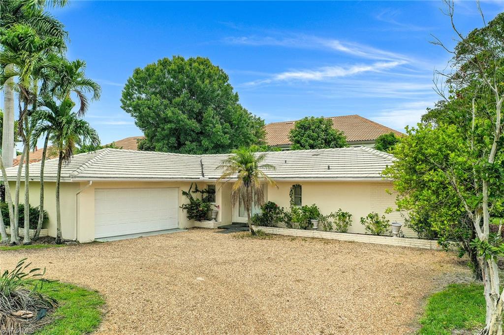 3888 Crayton Road Naples, FL 34103 - Photo 24 of 29 front view of a house with a yard