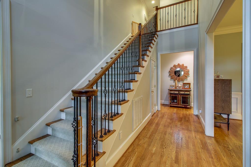 129 Page Road Nashville, TN 37205 - Photo 4 of 20 a view of a hallway with wooden floor and stairs