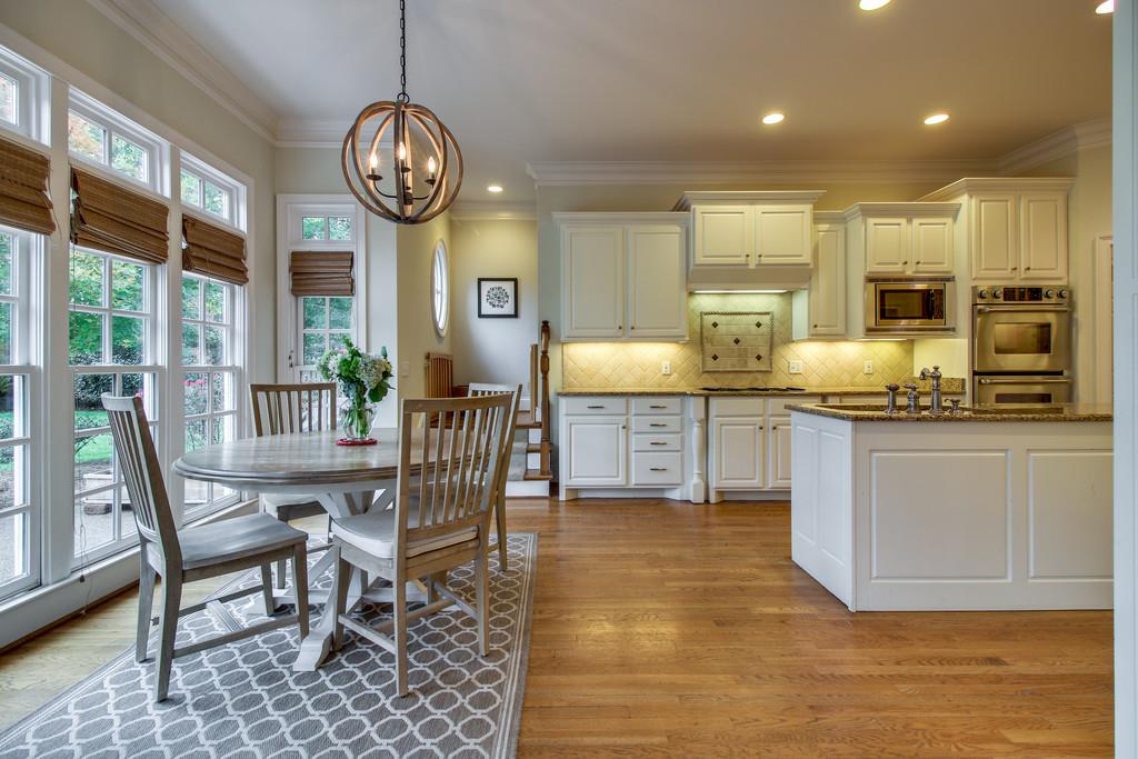 129 Page Road Nashville, TN 37205 - Photo 8 of 20 a large kitchen with granite countertop a stove a sink a dining table and chairs