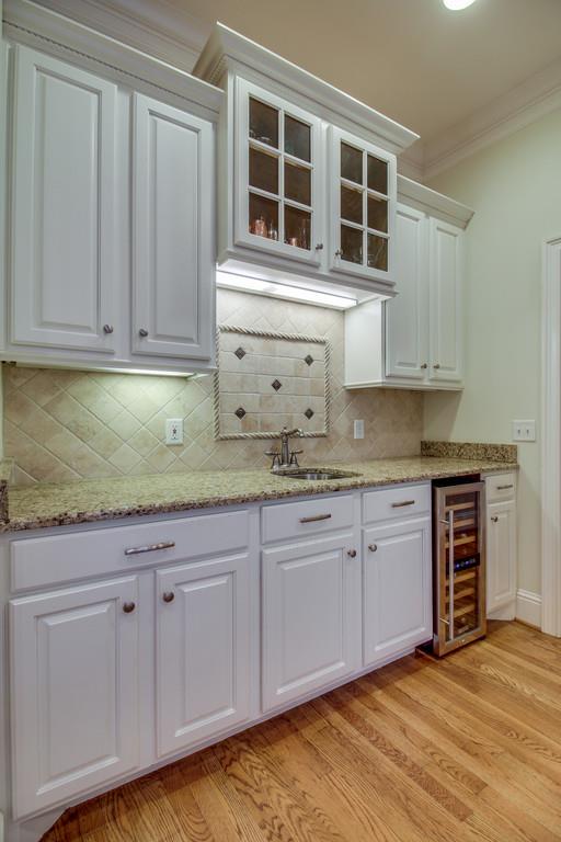 129 Page Road Nashville, TN 37205 - Photo 10 of 20 a kitchen with granite countertop white cabinets and stainless steel appliances