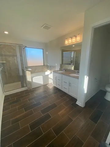 a bathroom with a granite countertop sink a mirror and shower