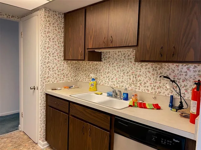 a kitchen with sink cabinets and utility