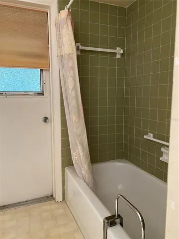 a bathroom with a granite countertop sink toilet and mirror