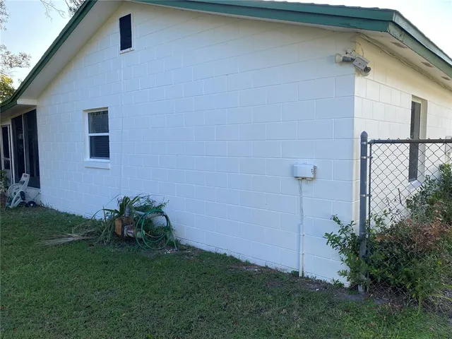 a view of a house with a yard and sitting area