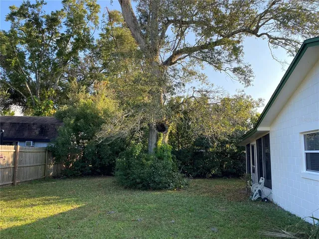 a view of yard with swimming pool and green space