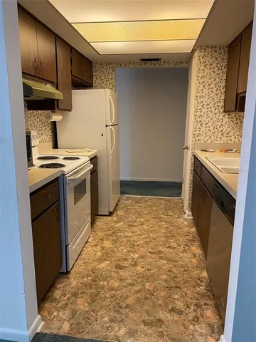 a kitchen with a stove and a refrigerator