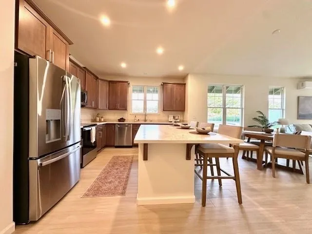 a bathroom with a granite countertop sink mirror and a toilet
