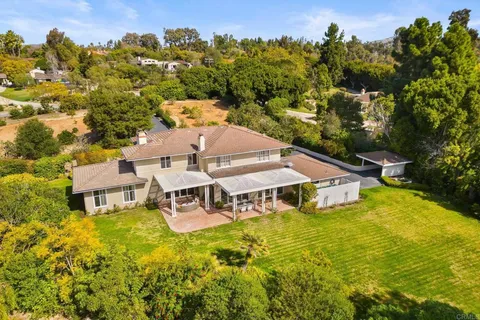 an aerial view of a house with swimming pool garden and mountain view