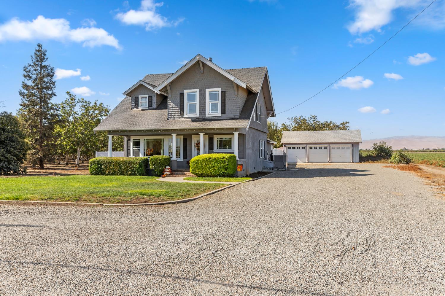 12407 Elm Avenue Patterson, CA 95363 - Photo 2 of 43 a front view of a house with a yard and garage