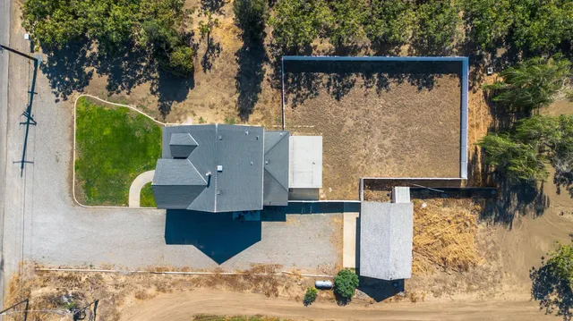 an aerial view of a house with a yard
