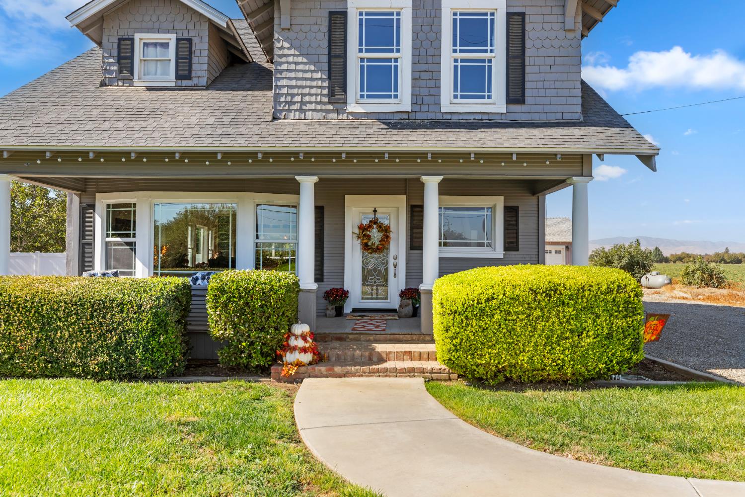 12407 Elm Avenue Patterson, CA 95363 - Photo 4 of 43 a front view of a house with garden