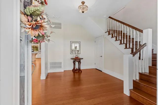 a view of entryway with a front door and wooden floor