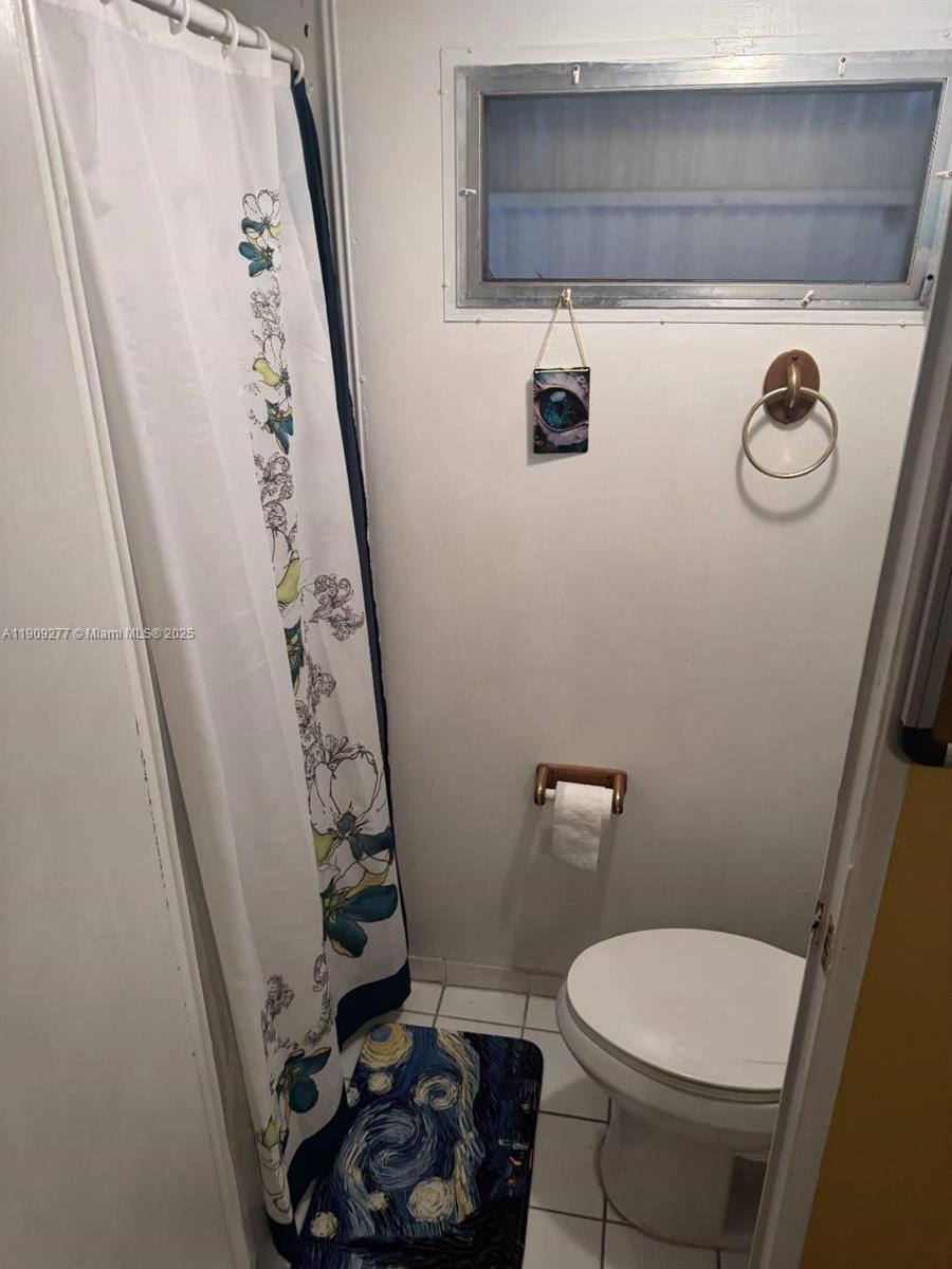 5470 Southwest 25th Way, Unit 5470 Dania Beach, FL 33312 - Photo 12 of 15 a bathroom with a toilet and a shower