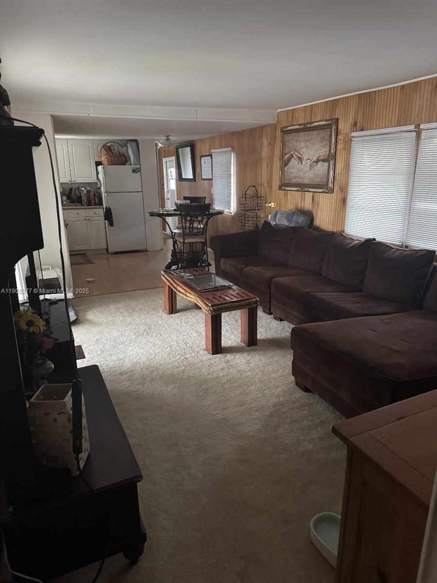5470 Southwest 25th Way, Unit 5470 Dania Beach, FL 33312 - Photo 13 of 15 a living room with furniture and a flat screen tv