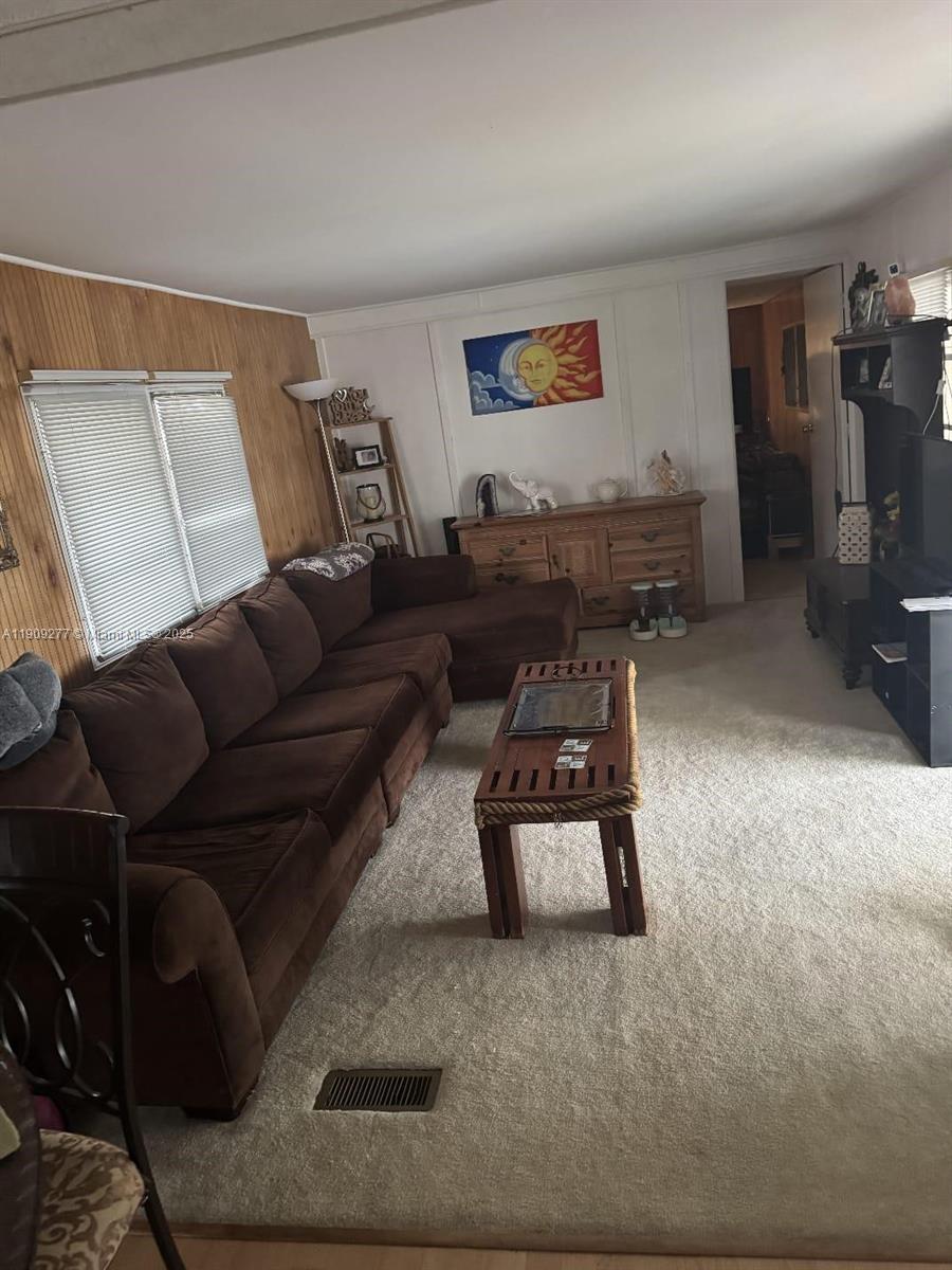 5470 Southwest 25th Way, Unit 5470 Dania Beach, FL 33312 - Photo 14 of 15 a living room with furniture and a flat screen tv
