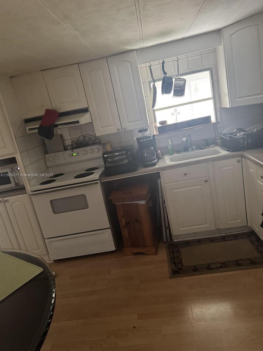 5470 Southwest 25th Way, Unit 5470 Dania Beach, FL 33312 - Photo 15 of 15 a kitchen with a stove and a sink