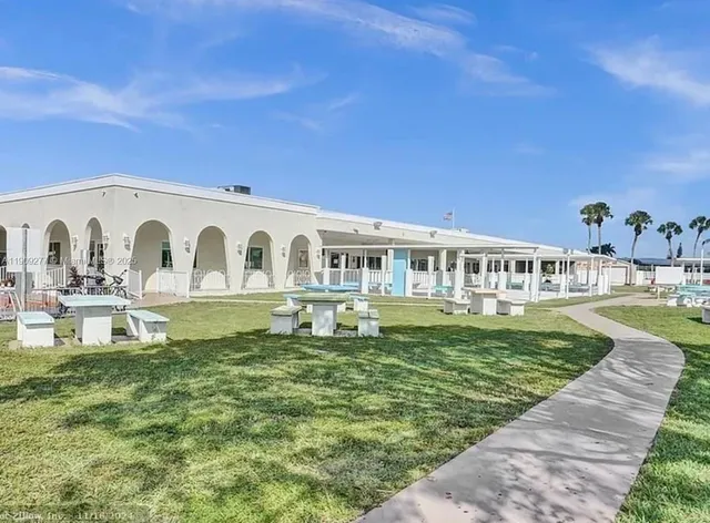 a view of a house with a yard porch and sitting area