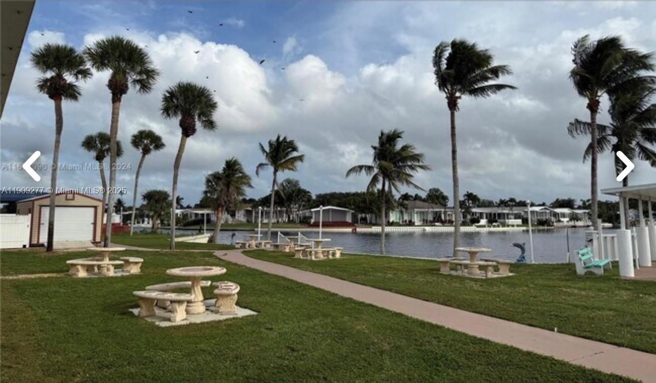 5470 Southwest 25th Way, Unit 5470 Dania Beach, FL 33312 - Photo 6 of 15 a view of a swimming pool and lake view