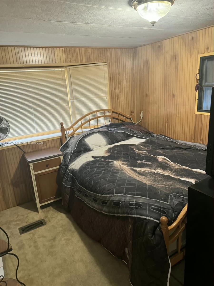 5470 Southwest 25th Way, Unit 5470 Dania Beach, FL 33312 - Photo 10 of 15 a bedroom with a bed and a dresser