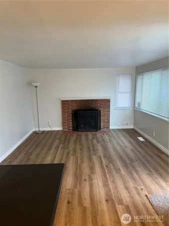 a view of empty room with a fireplace
