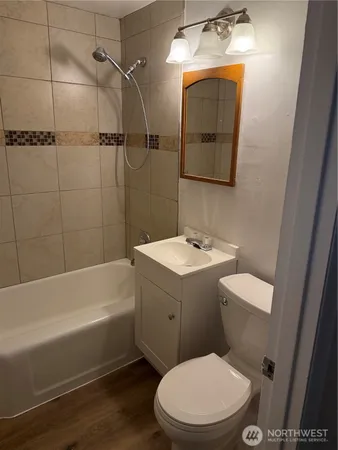 a bathroom with a toilet a sink and bathtub
