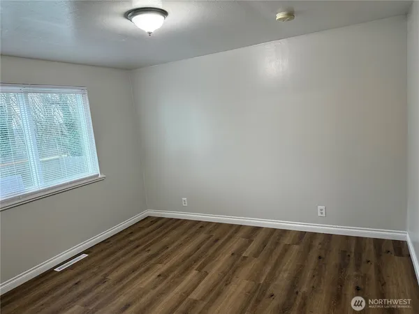 a bathroom with a sink vanity mirror and toilet