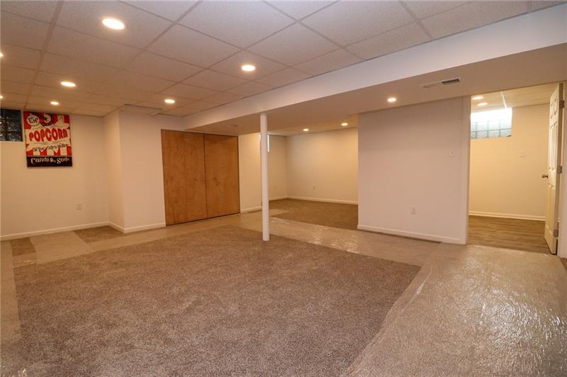 2279 Rochester Road Pittsburgh, PA 15237 - Photo 17 of 25 The Basement Has Been Finished to Have a Separate Laundry Area. Behind the Popcorn Poster is the Electrical Box.