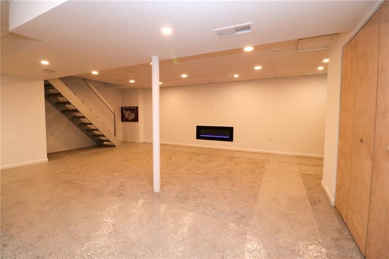 2279 Rochester Road Pittsburgh, PA 15237 - Photo 18 of 25 Plenty of Recessed Lighting Make the New Game Room Area Bright and Cozy. Curl up in Front of the Electric Fireplace and Enjoy a Quiet Moment....The Flame has Different Color Settings and also a Blower for Added Warmth.