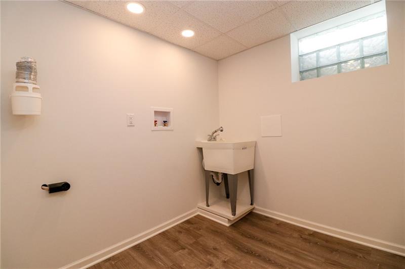 2279 Rochester Road Pittsburgh, PA 15237 - Photo 20 of 25 The Laundry Room with "Lifeproof" Flooring, Slop Sink, Recessed Lighting and Glass Block Window.