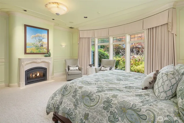 a bed sitting in a spacious bedroom next to a window